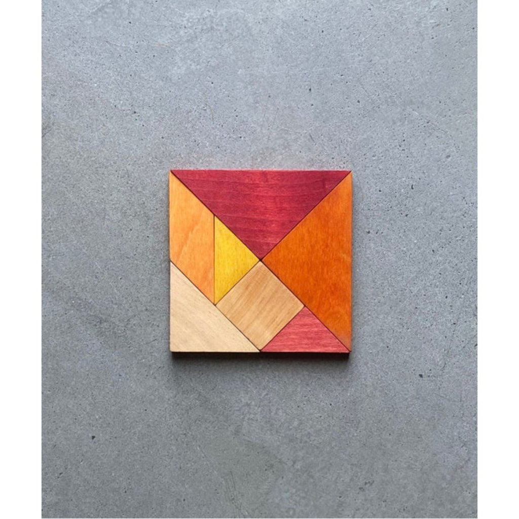 6. Wooden Story tangram set in warm colors arranged in a square on a grey background