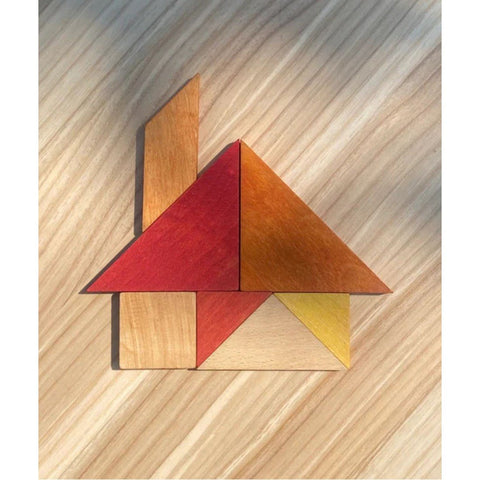 2. Wooden Story tangram pieces forming a house shape on a wooden surface