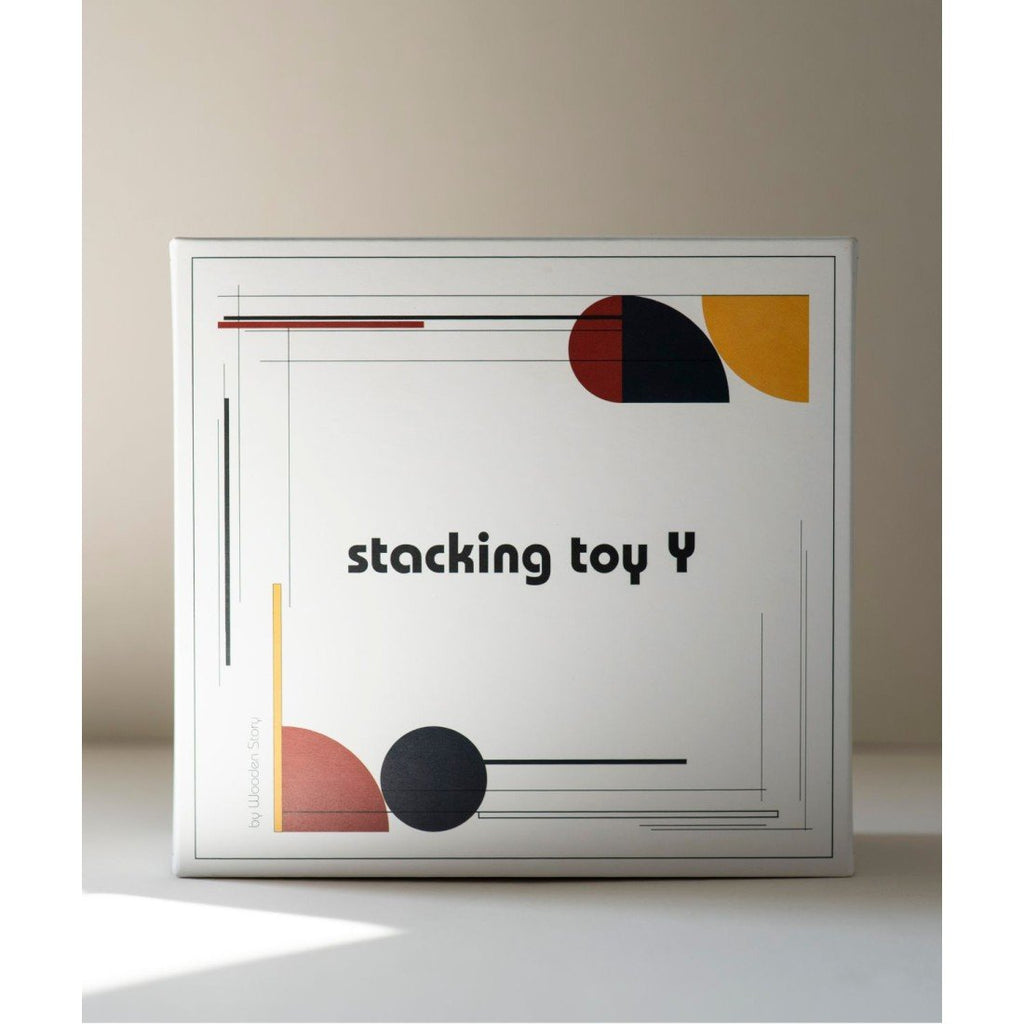 4. Packaging of Wooden Story's stacking toy Y with geometric design and text on a light background