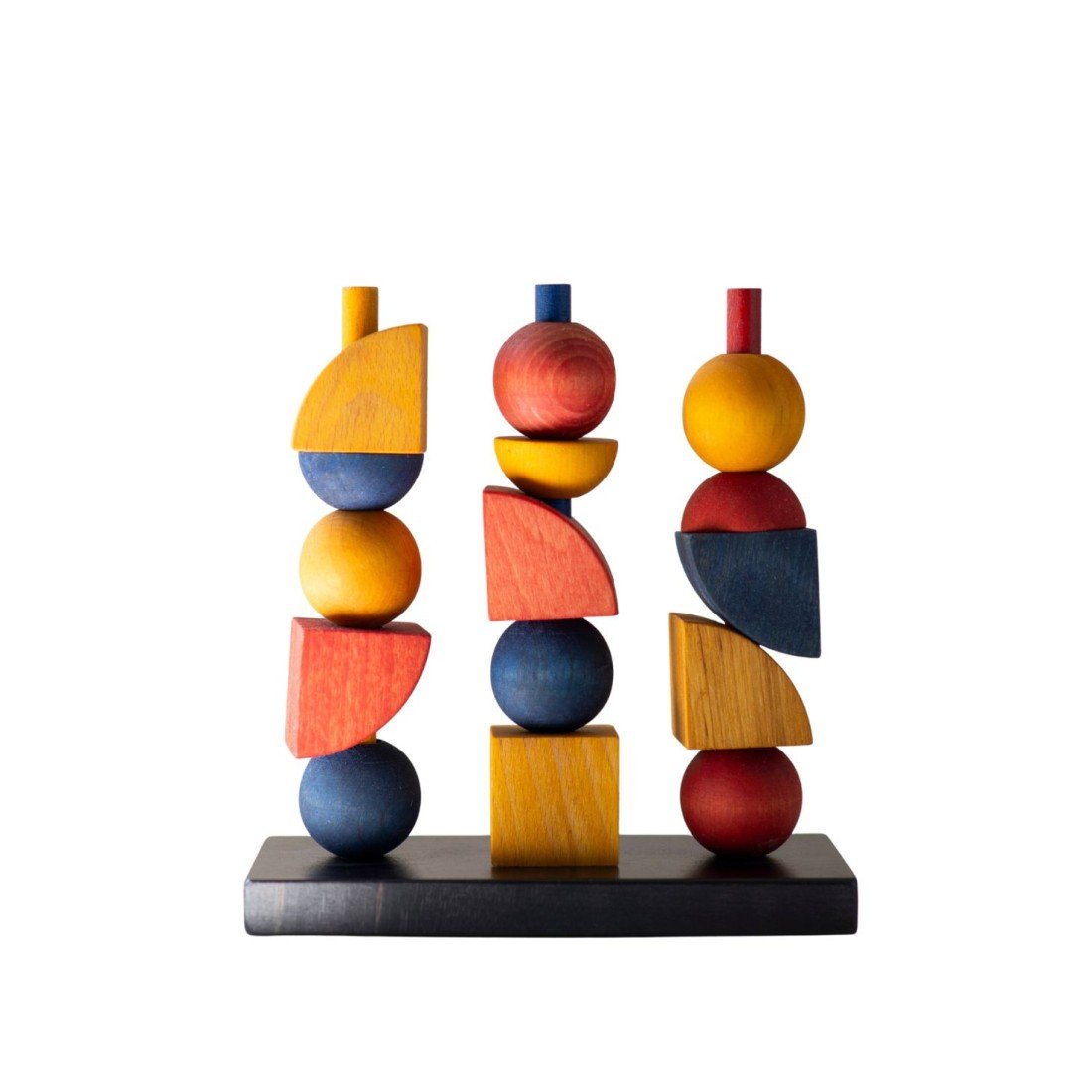2. Bauhaus-inspired wooden stacking toy with colorful geometric shapes on a black base, studio setting