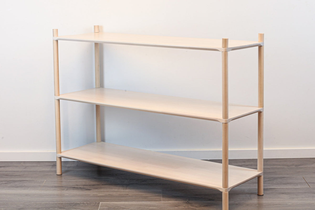 2. Montessori-inspired wooden shelving unit with three shelves, shown in a studio setting with a side view