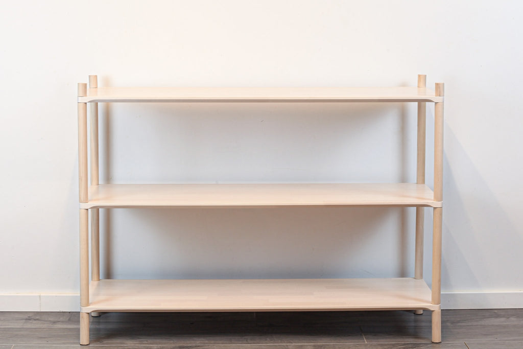 3. Montessori-inspired wooden shelving unit with three shelves, shown in a studio setting with a front view