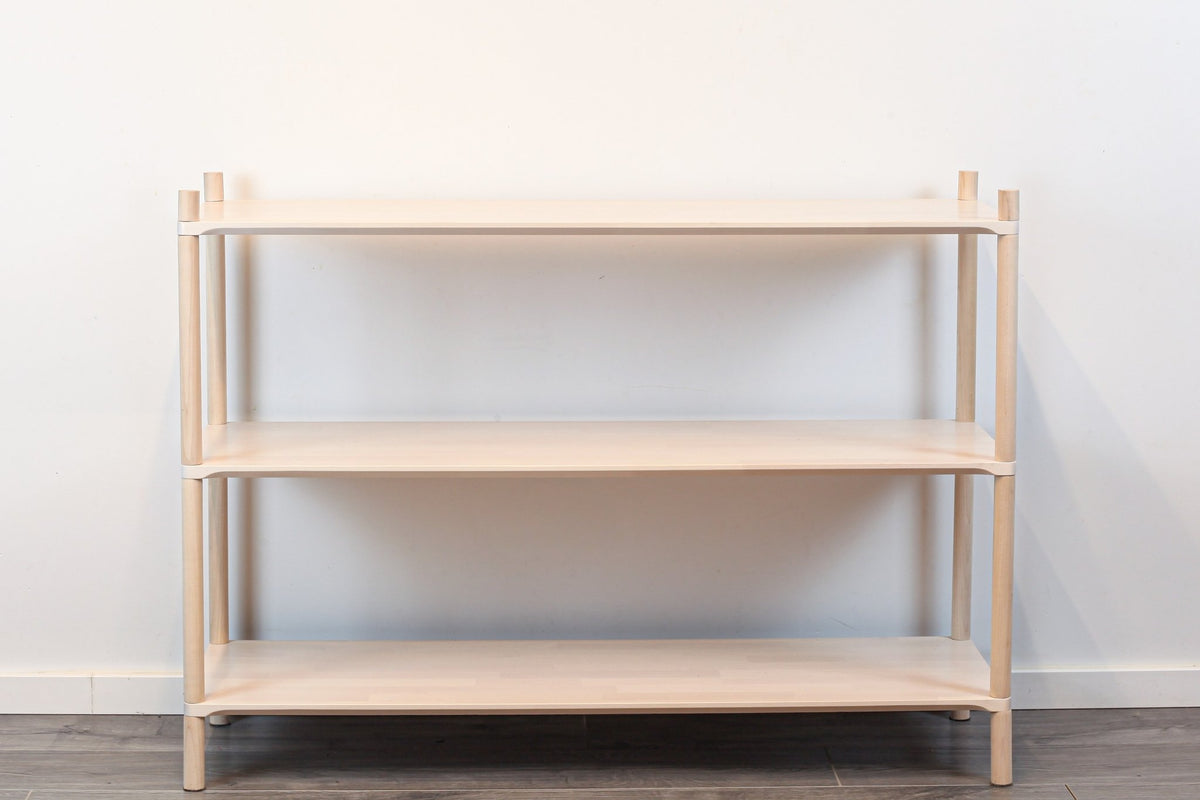 3. Montessori-inspired wooden shelving unit with three shelves, shown in a studio setting with a front view