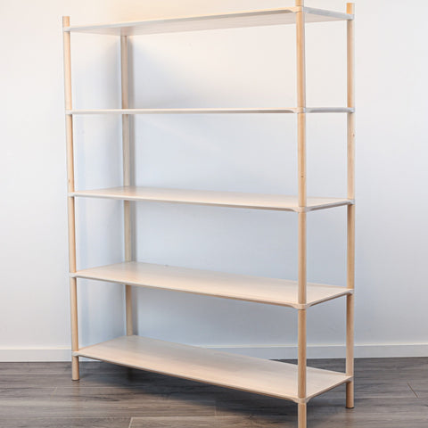 3. Side view of Montessori-inspired wooden shelving unit with five shelves, showcasing rounded corners and natural birch wood finish