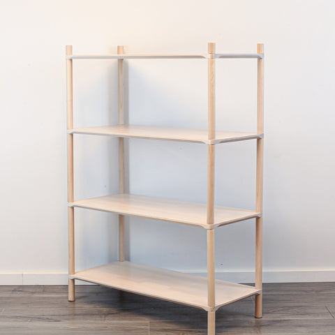 3. Side view of Montessori-inspired wooden shelving unit with four shelves, showcasing rounded corners and natural birch wood finish