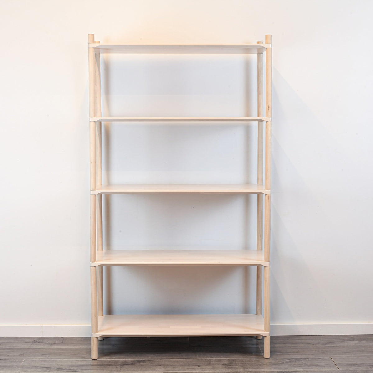 3. Front view of Montessori-inspired wooden shelving unit with five shelves, showcasing simple and practical design