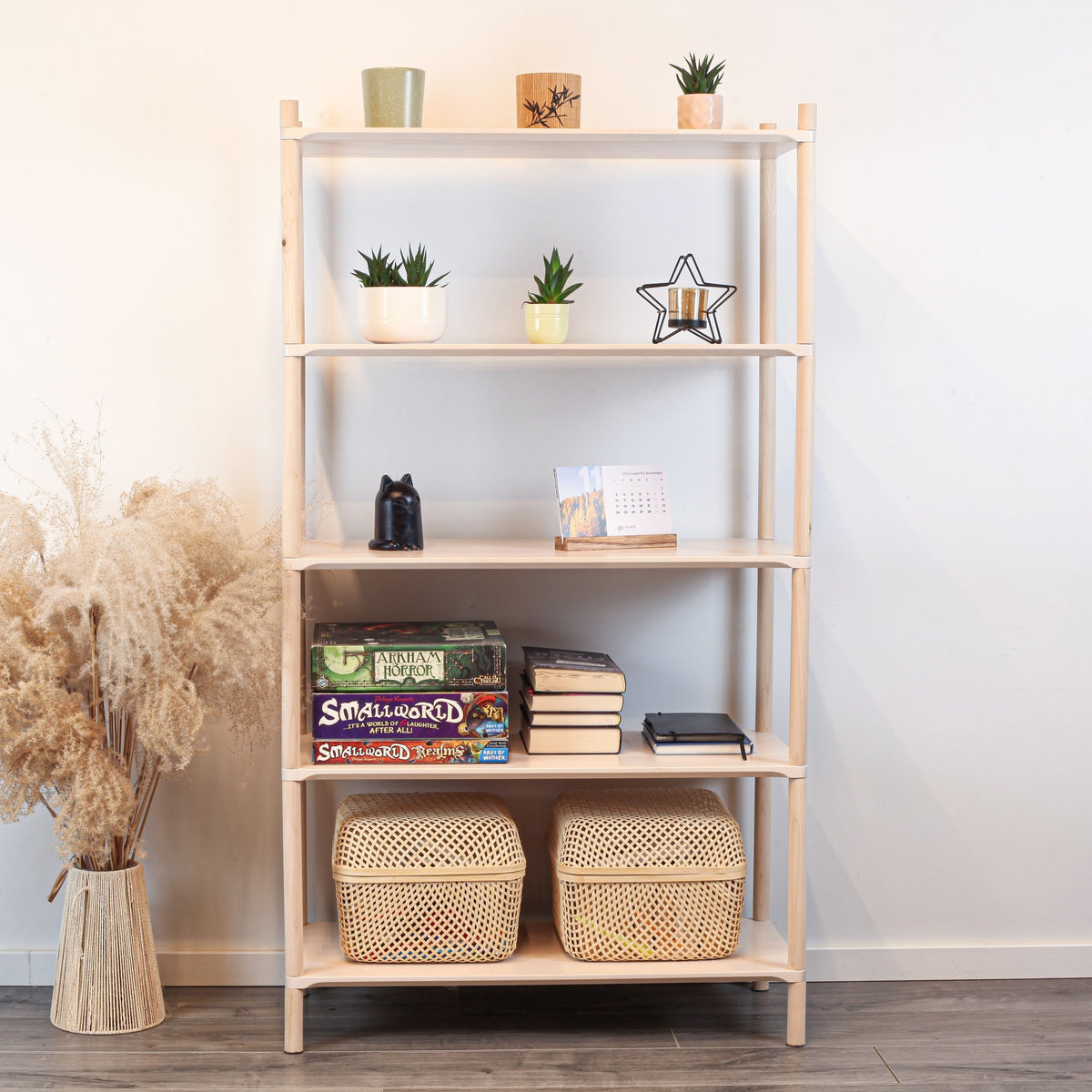 1. Montessori-inspired wooden shelving unit with five shelves, decorated with plants, books, and baskets, in a natural home setting