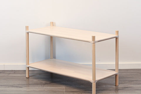2. Studio shot of Montessori-inspired wooden shelving unit with two shelves, made from natural birch wood