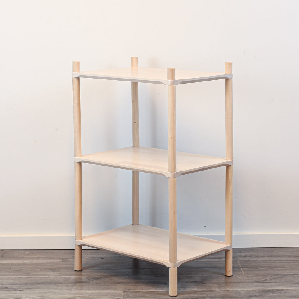 3. Side angle of Montessori-inspired wooden shelving unit with three shelves, showcasing rounded corners and natural birch wood finish