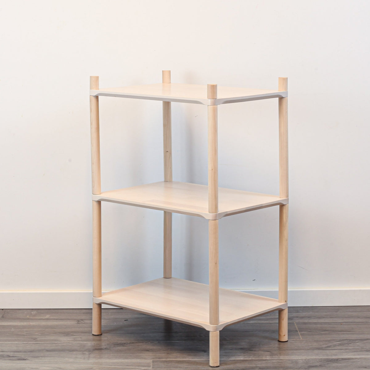 3. Side angle of Montessori-inspired wooden shelving unit with three shelves, showcasing rounded corners and natural birch wood finish