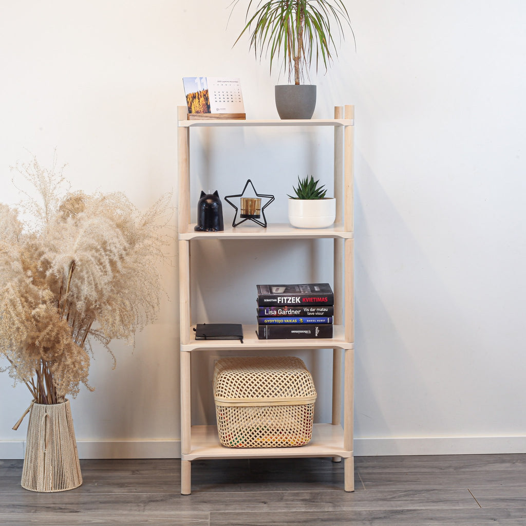 1. Montessori-inspired wooden shelving unit with four shelves, styled with books, plants, and decor items, placed against a white wall with a vase of pampas grass on the side