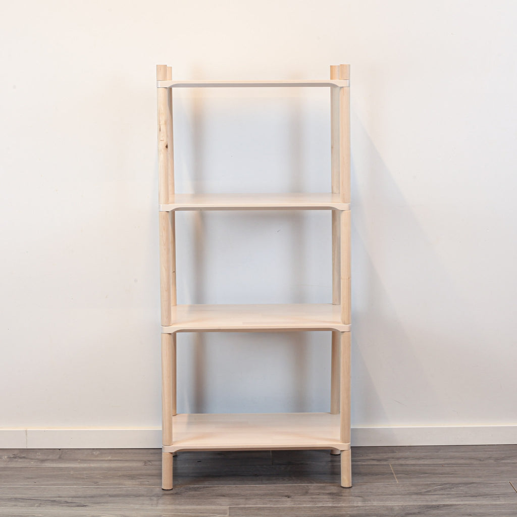 3. Front view of Montessori-inspired wooden shelving unit with four shelves, crafted from natural birch wood, displayed against a white wall