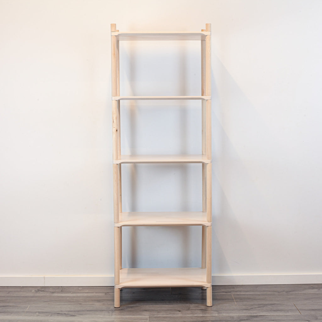 3. Front view of Montessori-inspired wooden shelving unit with five shelves, crafted from natural birch wood, displayed against a white wall