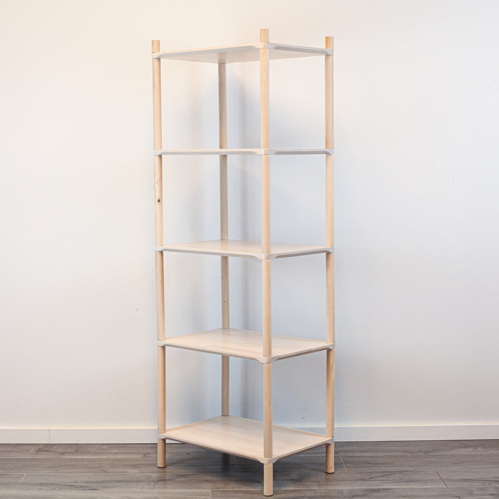 2. Studio shot of Montessori-inspired wooden shelving unit with five shelves, made from natural birch wood, shown at an angle against a plain white background