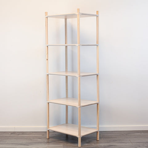 2. Studio shot of Montessori-inspired wooden shelving unit with five shelves, made from natural birch wood, shown at an angle against a plain white background