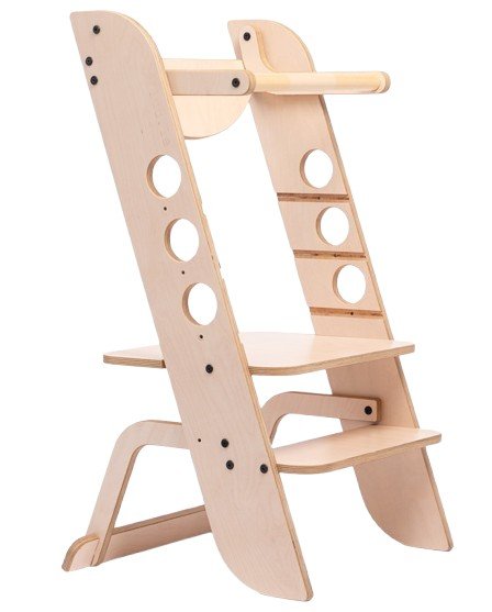 2. Wooden Montessori learning tower with circular cutouts and adjustable platform