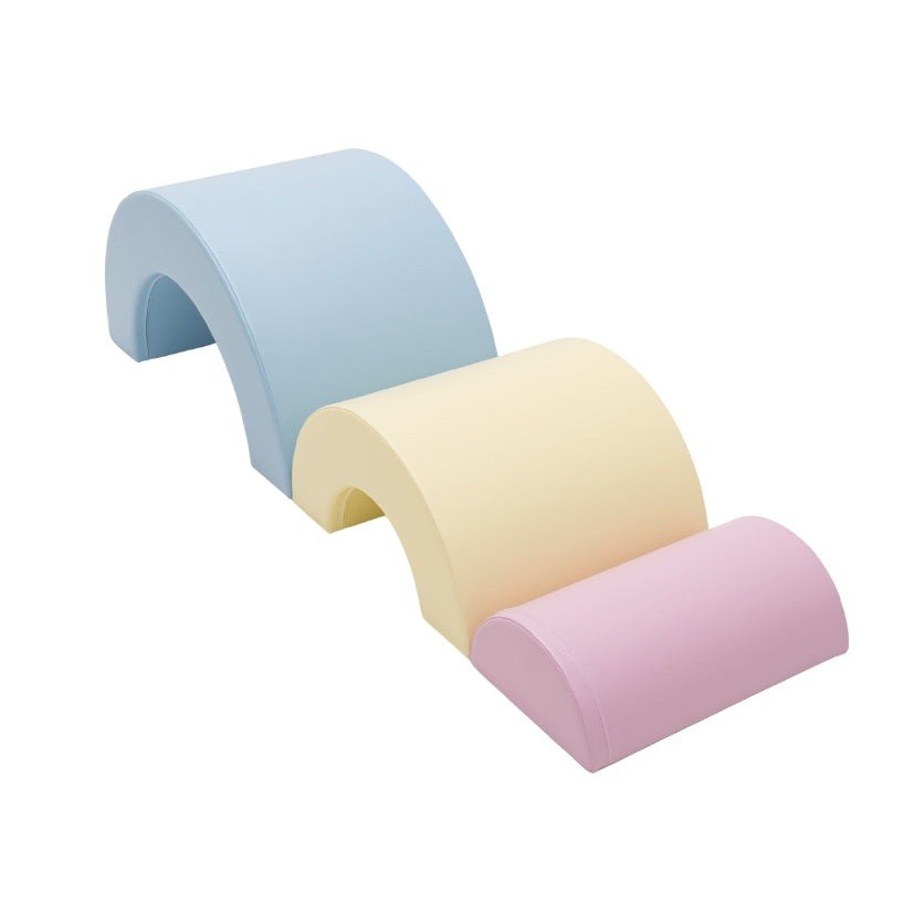3. Detail shot of Montessori soft play set in light pastel colors, featuring blue, yellow, and pink foam arches arranged in a wave pattern
