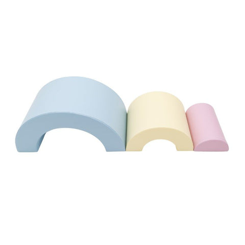 4. Flat lay of Montessori soft play set in light pastel colors, showing blue, yellow, and pink foam arches in descending size order