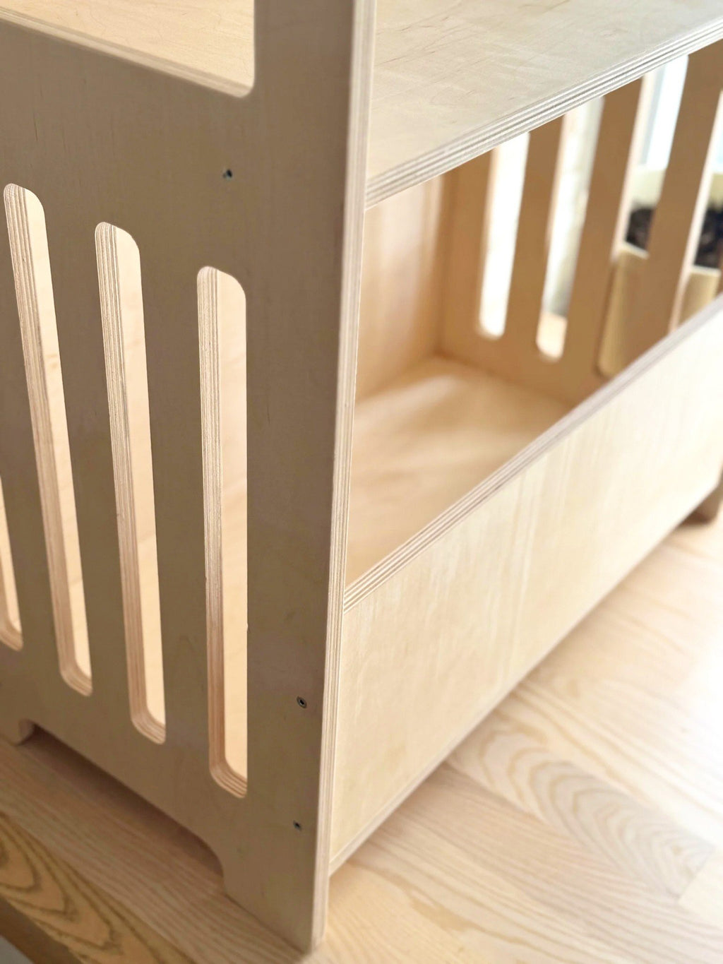 3. Close-up of Montessori wooden shelf showing smooth edges and sturdy construction in birch plywood