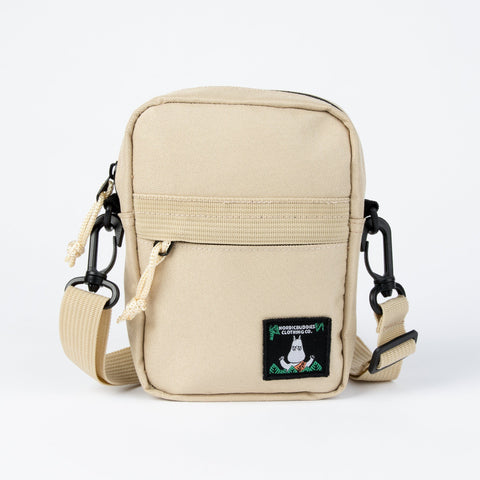2. Beige Moomin 80 cross body bag by NordicBuddies with adjustable strap and front pocket on white background