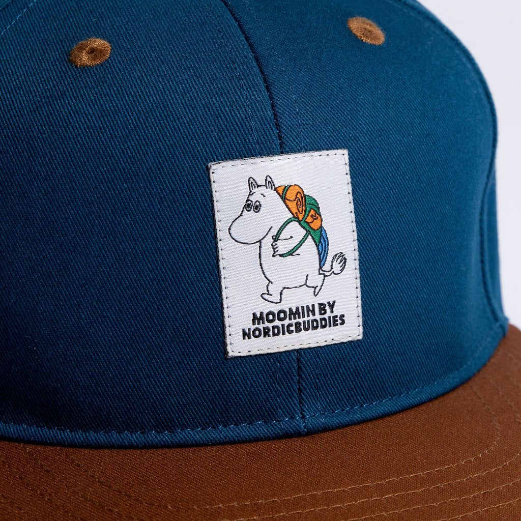 3. Close-up of Moomin by NordicBuddies logo on blue cotton fabric of kids flat cap