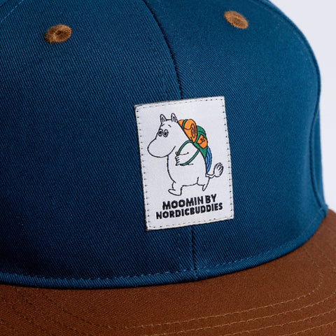 3. Close-up of Moomin by NordicBuddies logo on blue cotton fabric of kids flat cap