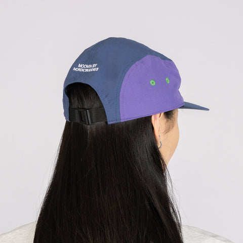 4. Back view of Moomintroll Adventure Nylon 5-panel Cap in blue and lilac worn by model