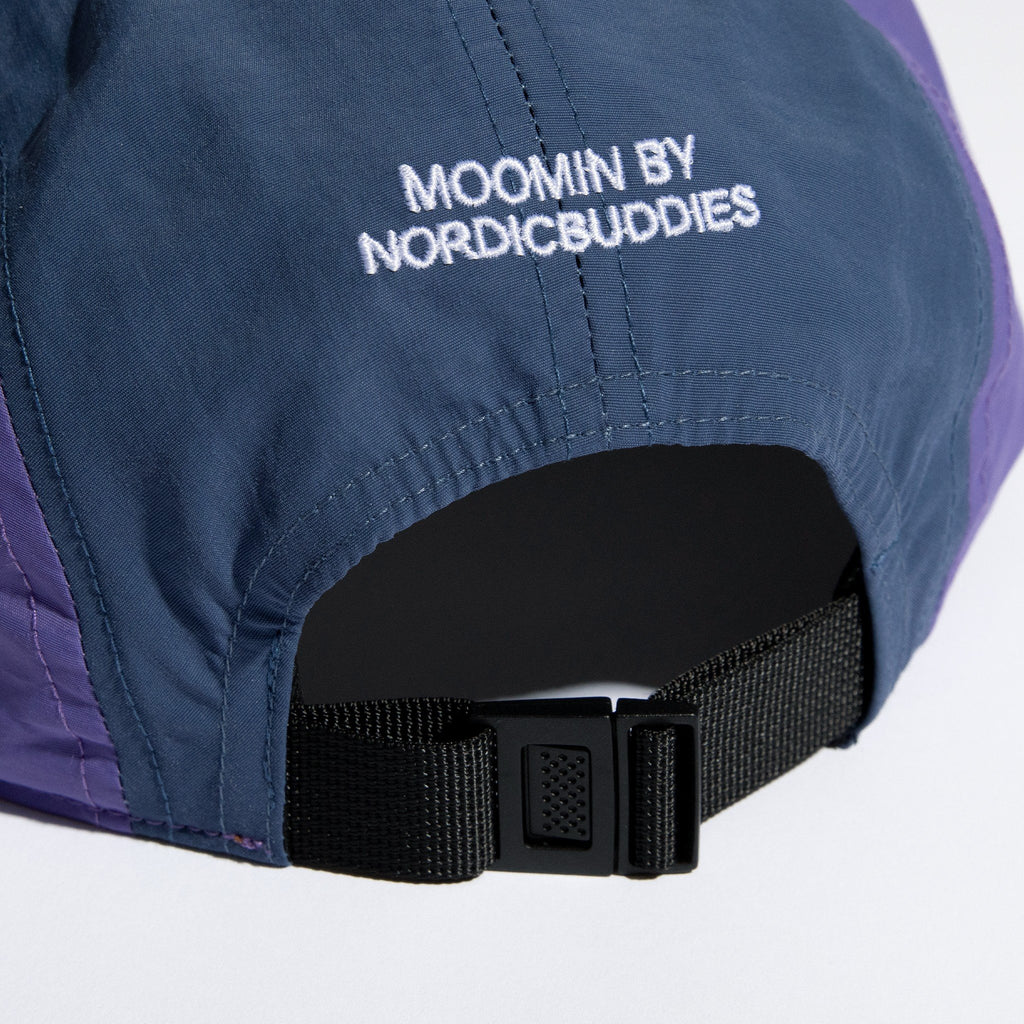 3. Close-up of Moomin by NordicBuddies branding on blue and lilac cap with adjustable strap