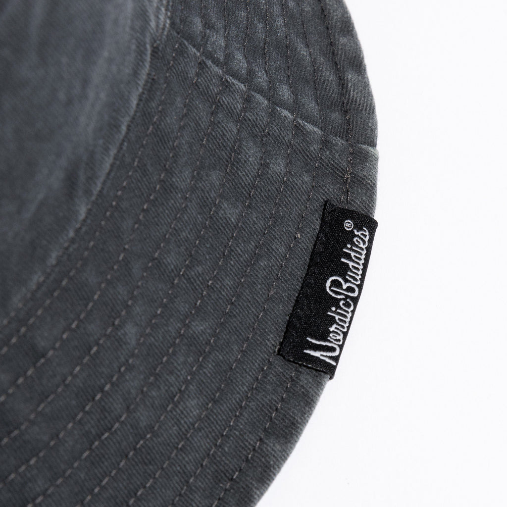 3. Close-up of NordicBuddies label on black washed denim bucket hat