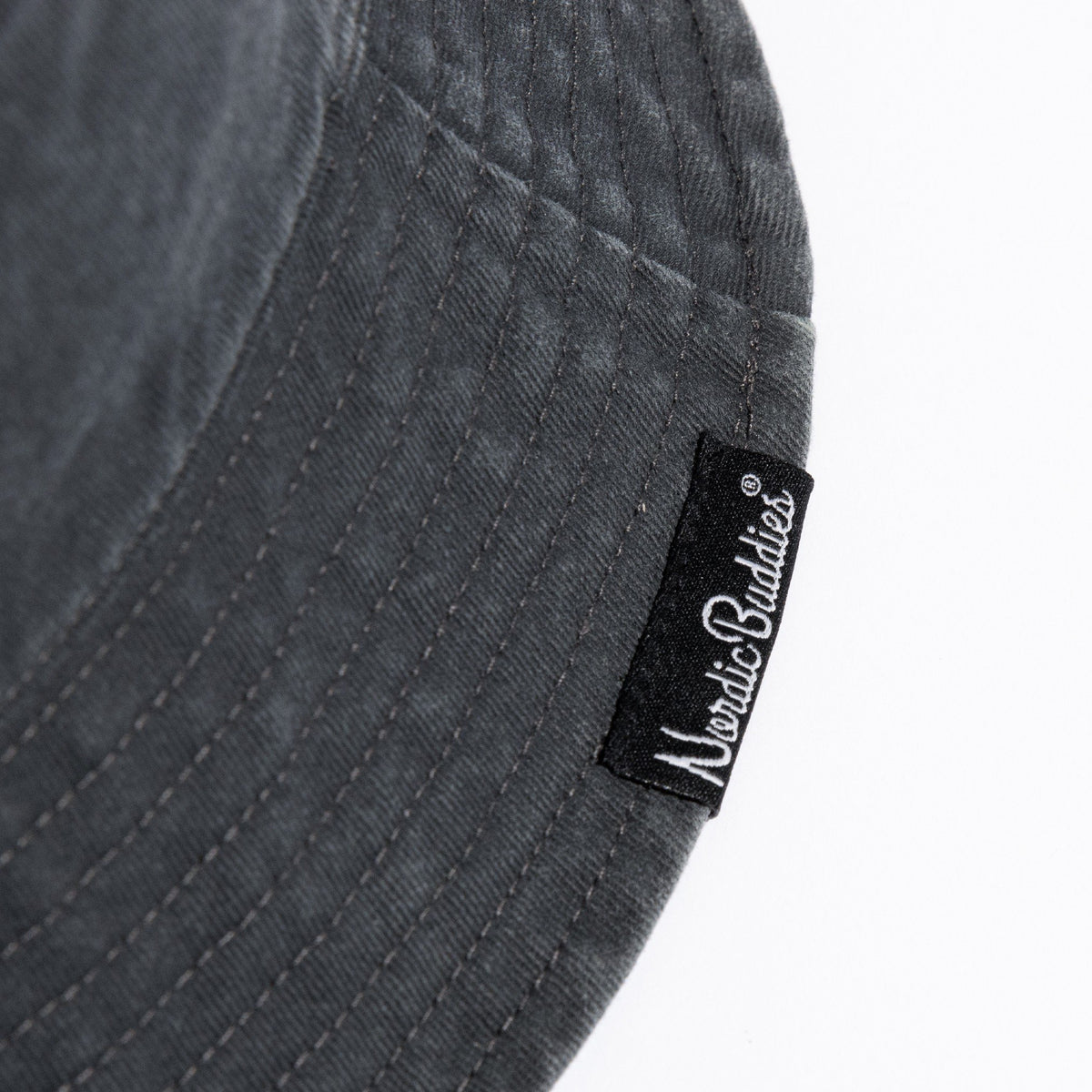 3. Close-up of NordicBuddies label on black washed denim bucket hat