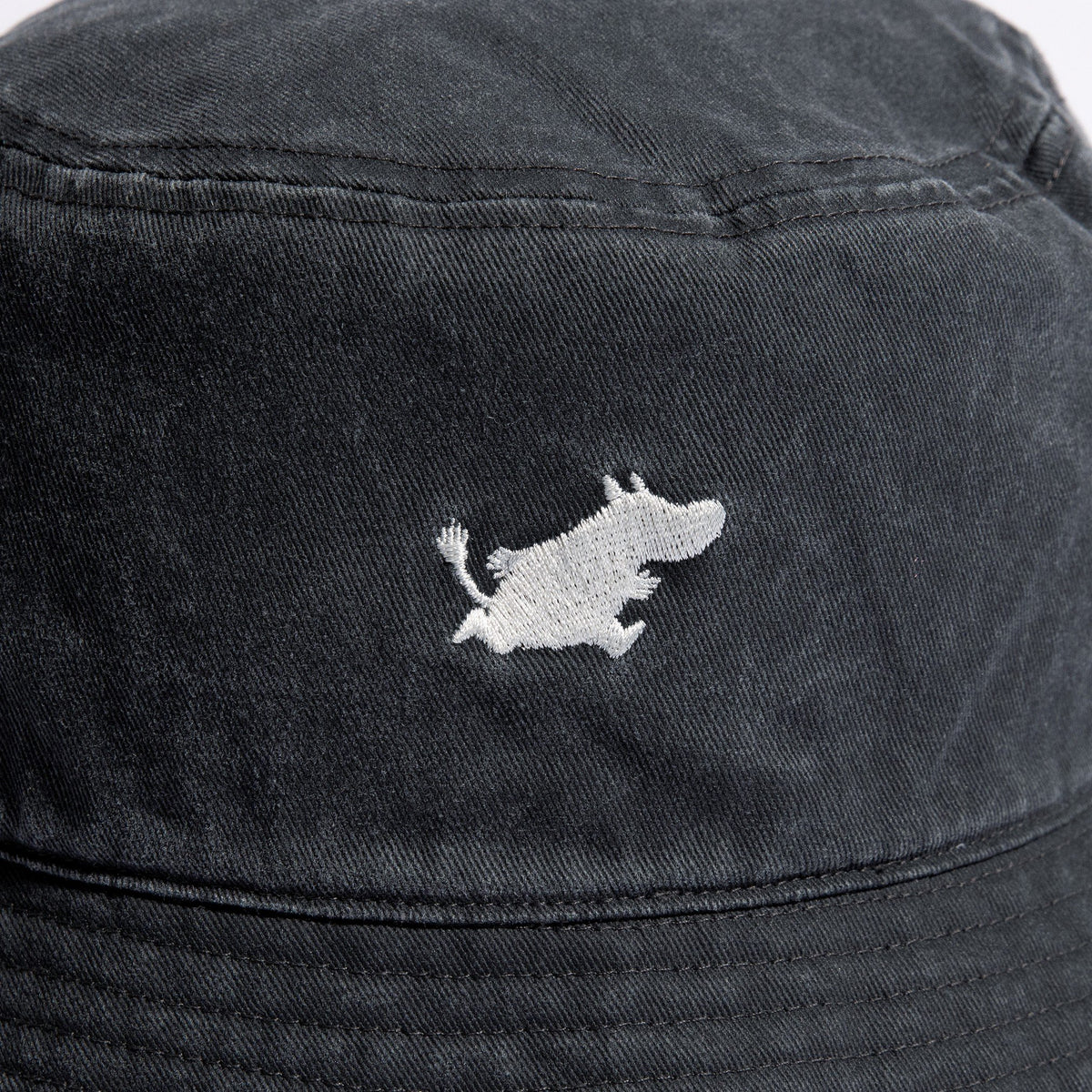 4. Close-up of embroidered Moomin character on black washed denim bucket hat