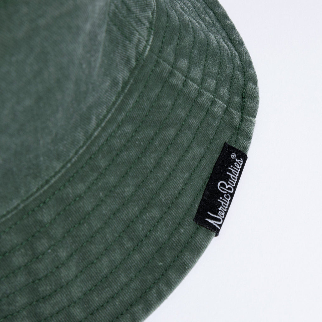 4. Close-up of NordicBuddies label on green washed denim bucket hat brim
