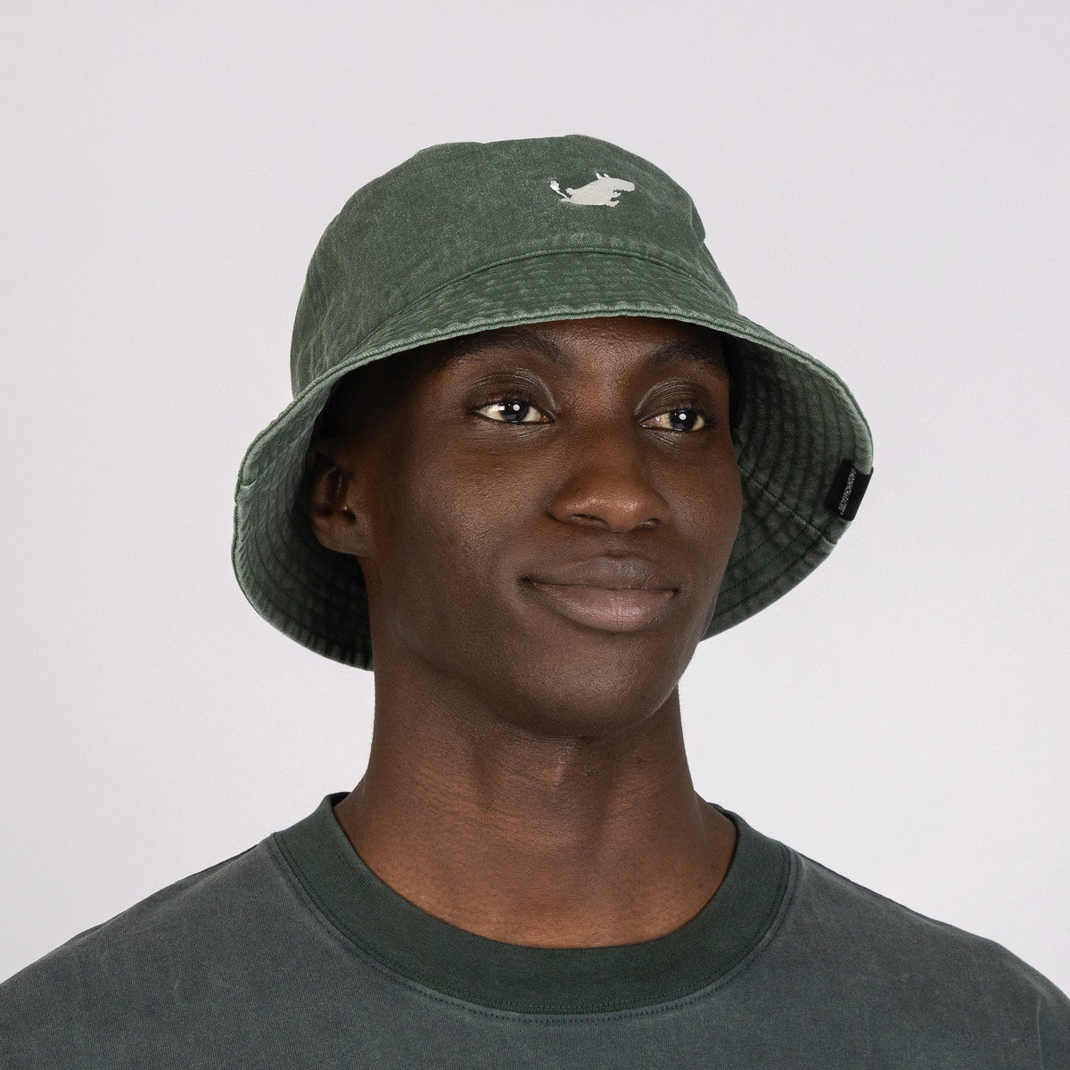 1. Men's green Moomin Classics washed denim bucket hat worn by model, showcasing front design in studio