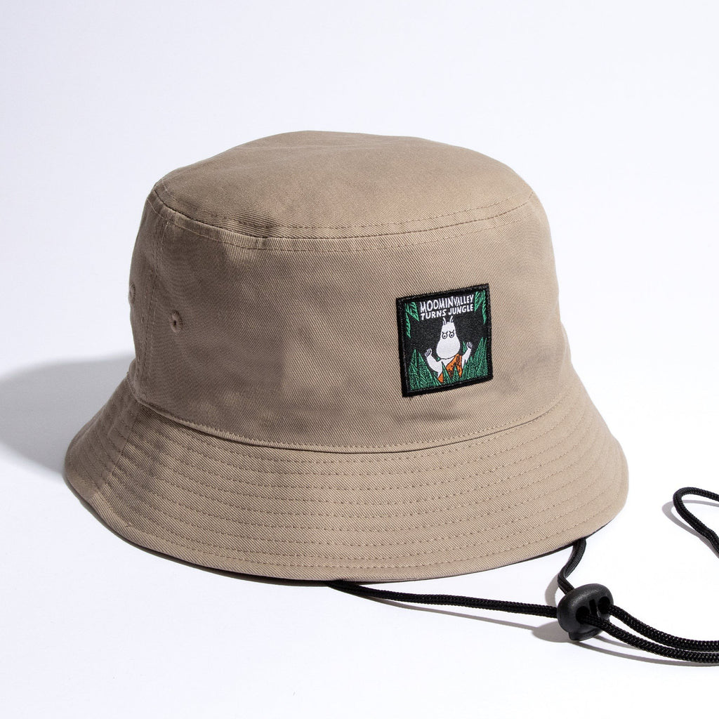 1. Moomin Jungle adult bucket hat in beige with embroidered patch, shown in studio setting