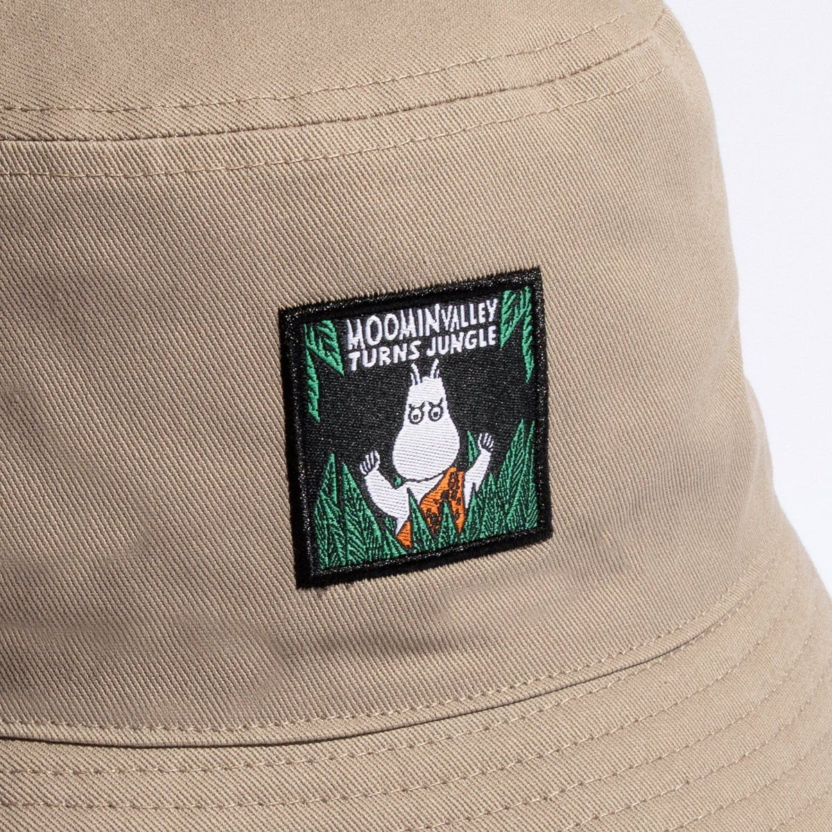 3. Close-up of Moominvalley Turns Jungle patch on beige bucket hat