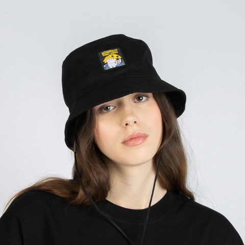 2. Female model in studio wearing Moomin Jungle black bucket hat, highlighting Moomin design