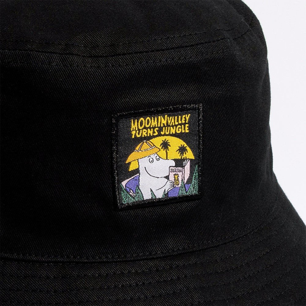 4. Close-up of Moomin Jungle patch on black bucket hat, showing Moomin character and jungle theme