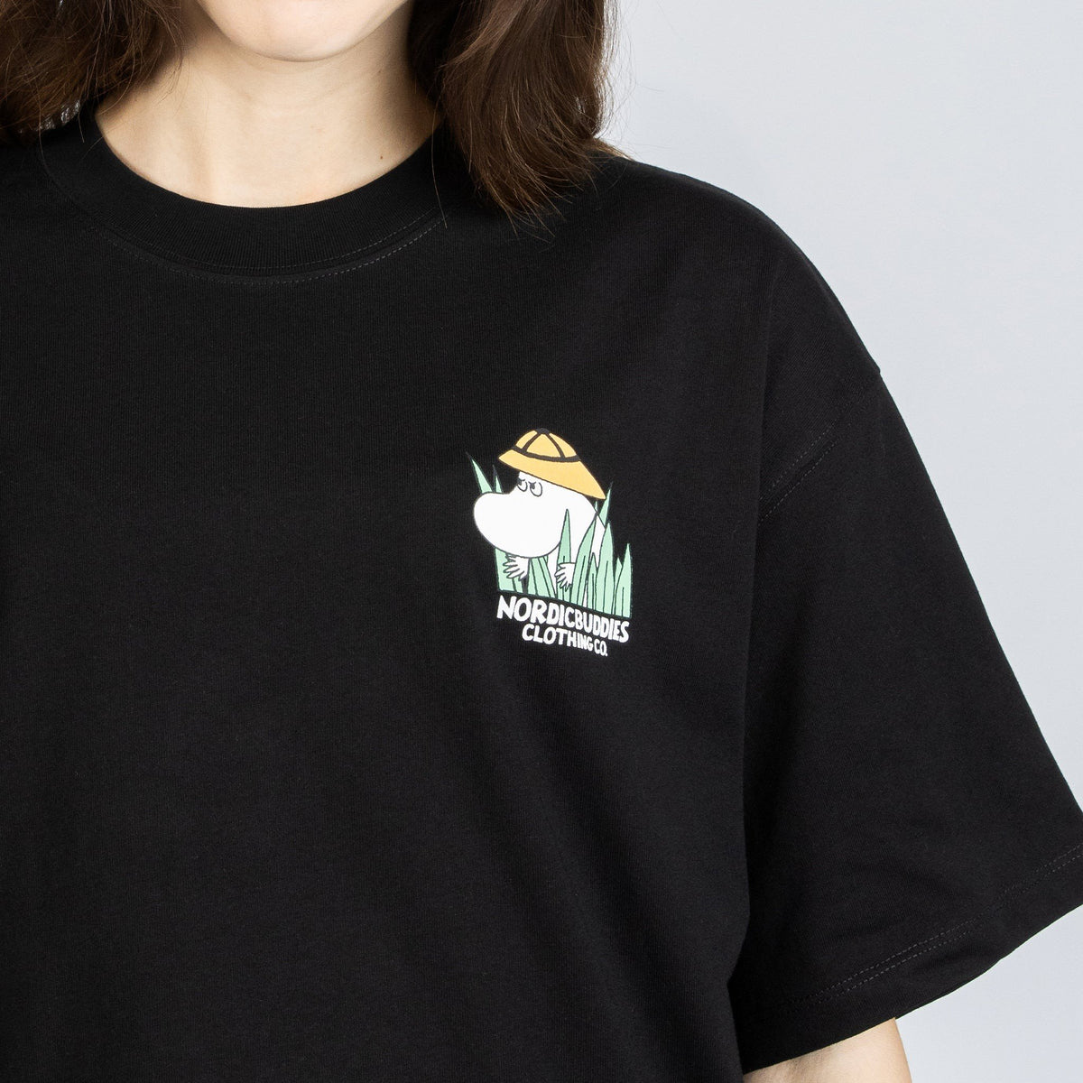 6. Front view of black Moomin Jungle t-shirt with small Moomin logo