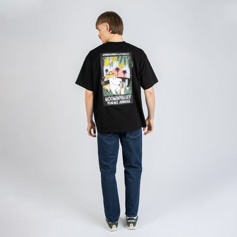 2. Female model wearing black Moomin Jungle t-shirt with small front logo, styled with jeans in studio
