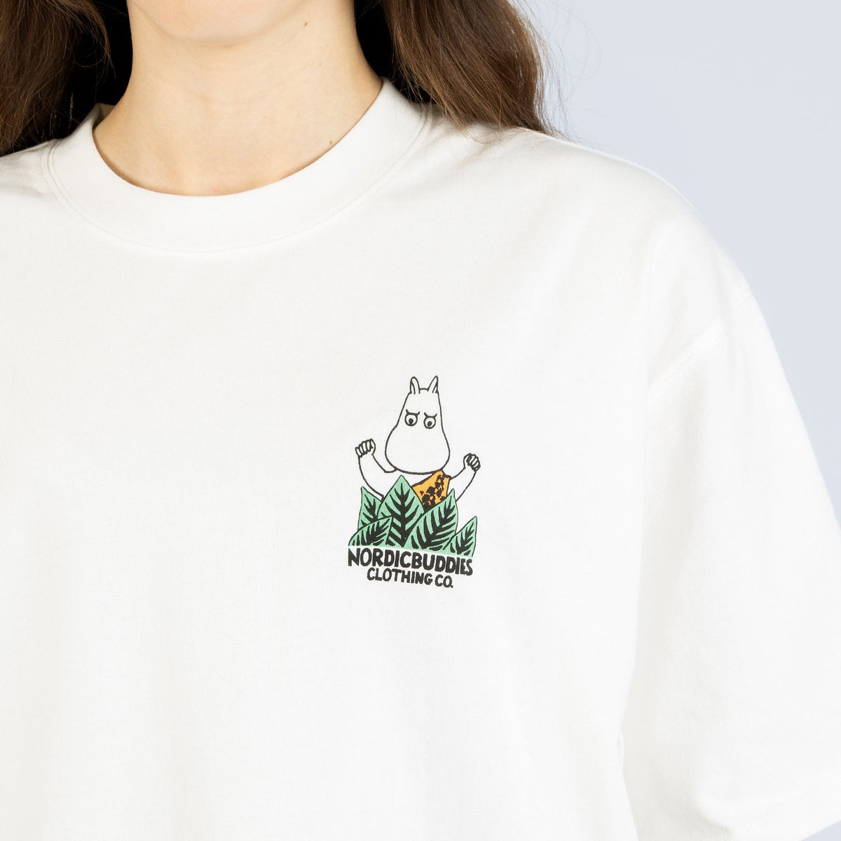6. Close-up of Moomin logo on white Jungle t-shirt, highlighting detailed embroidery