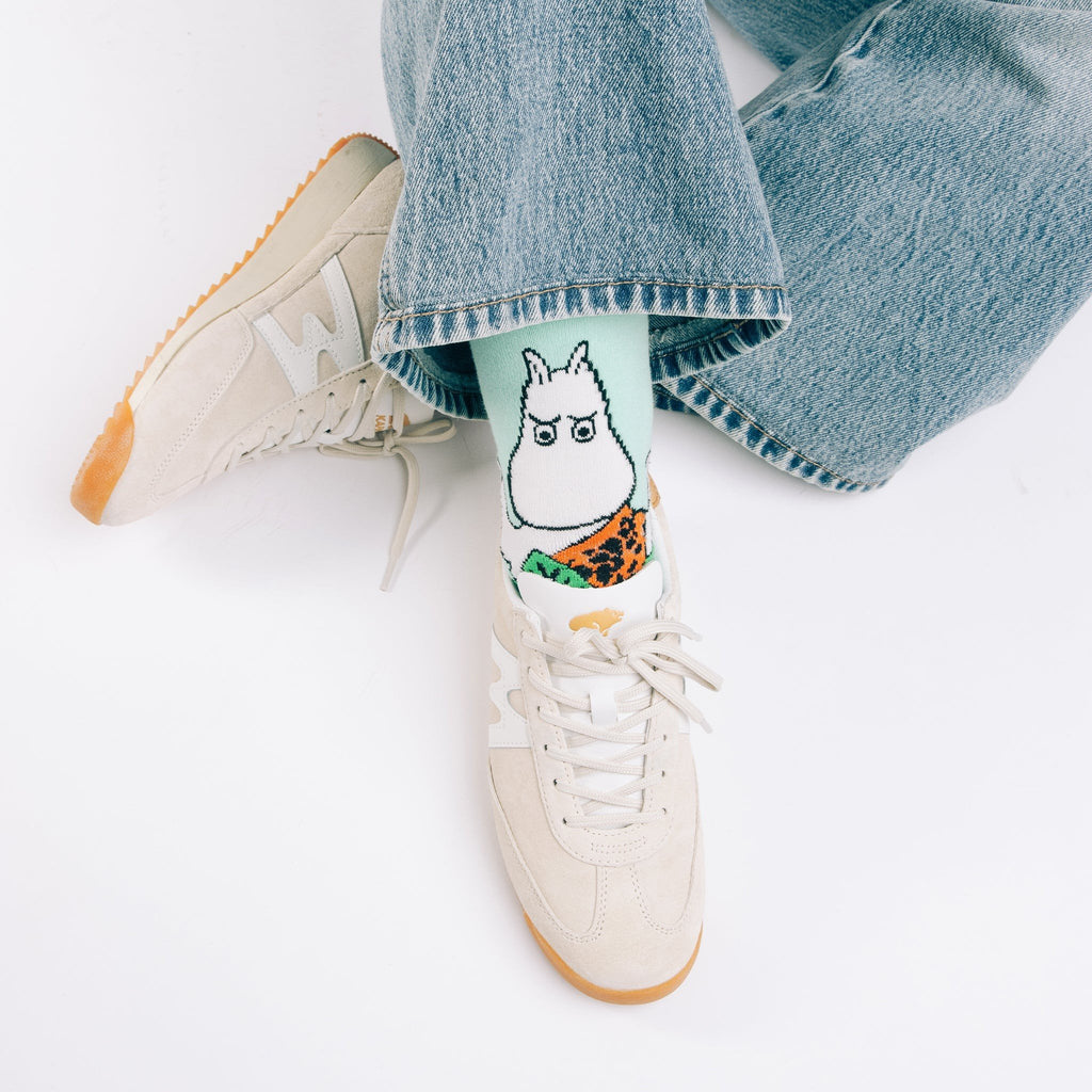 1. Moomin Jungle women's retro socks in green worn with casual sneakers and jeans, showcasing playful Moomin design