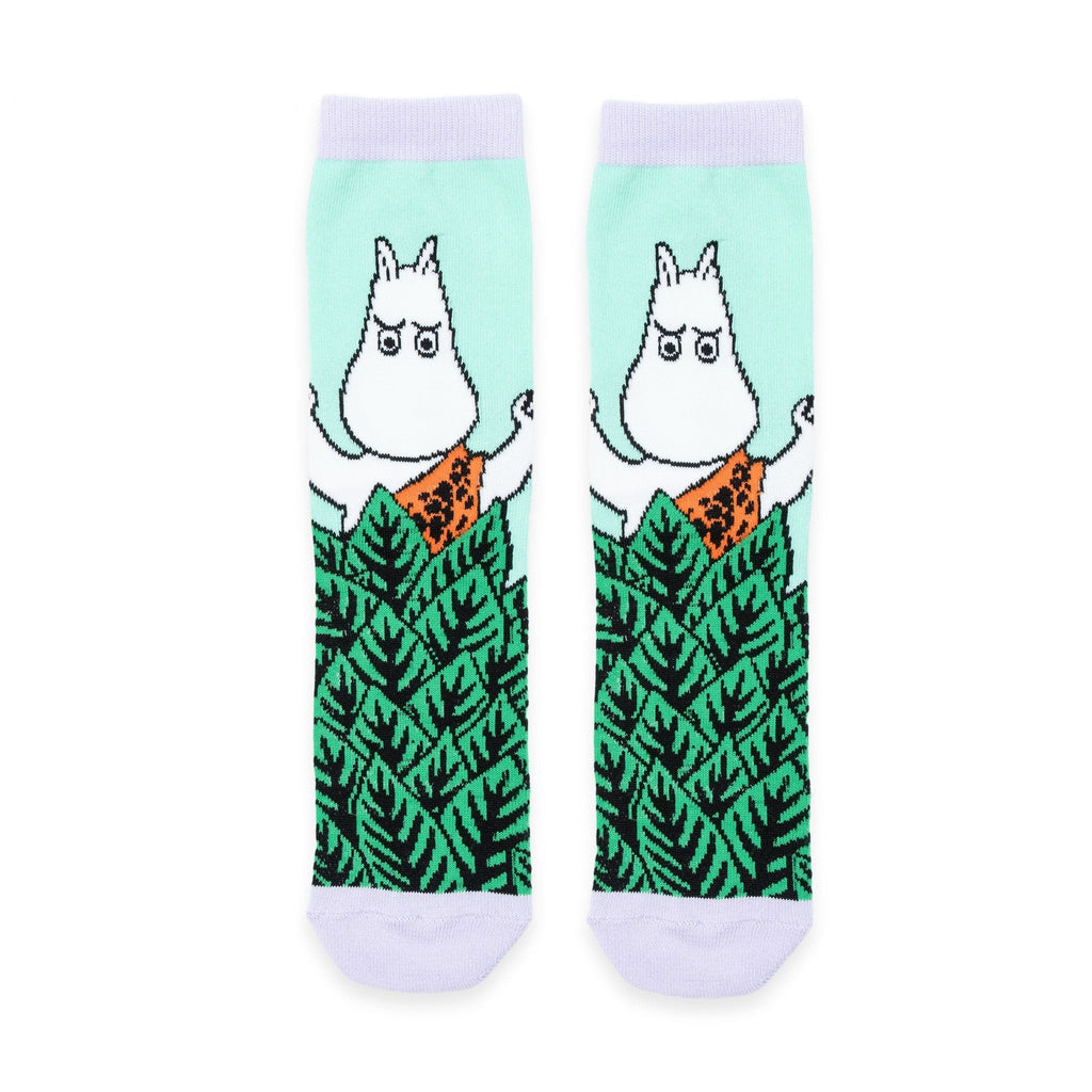2. Flat lay of Moomin Jungle women's retro socks in vibrant green with whimsical Moomin character and jungle leaf pattern