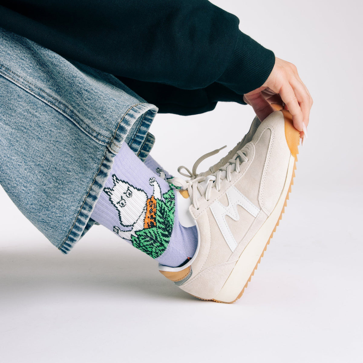 1. Women's Moomin Jungle Retro Socks in purple worn with sneakers, showcasing playful design