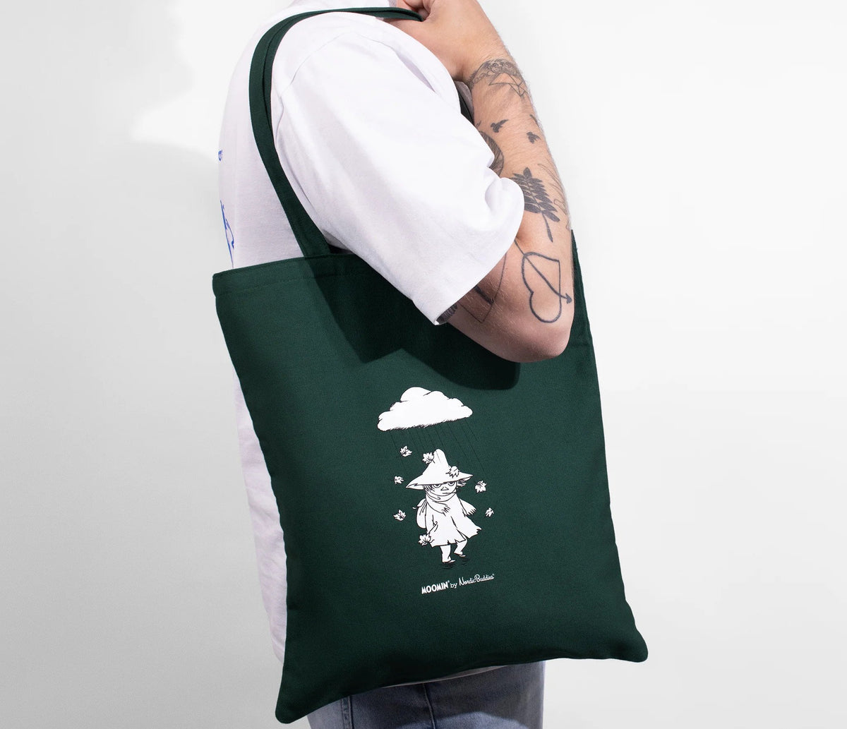 1. Unisex green Snufkin tote bag by Moomin worn by a model, showcasing eco-friendly design and Snufkin illustration