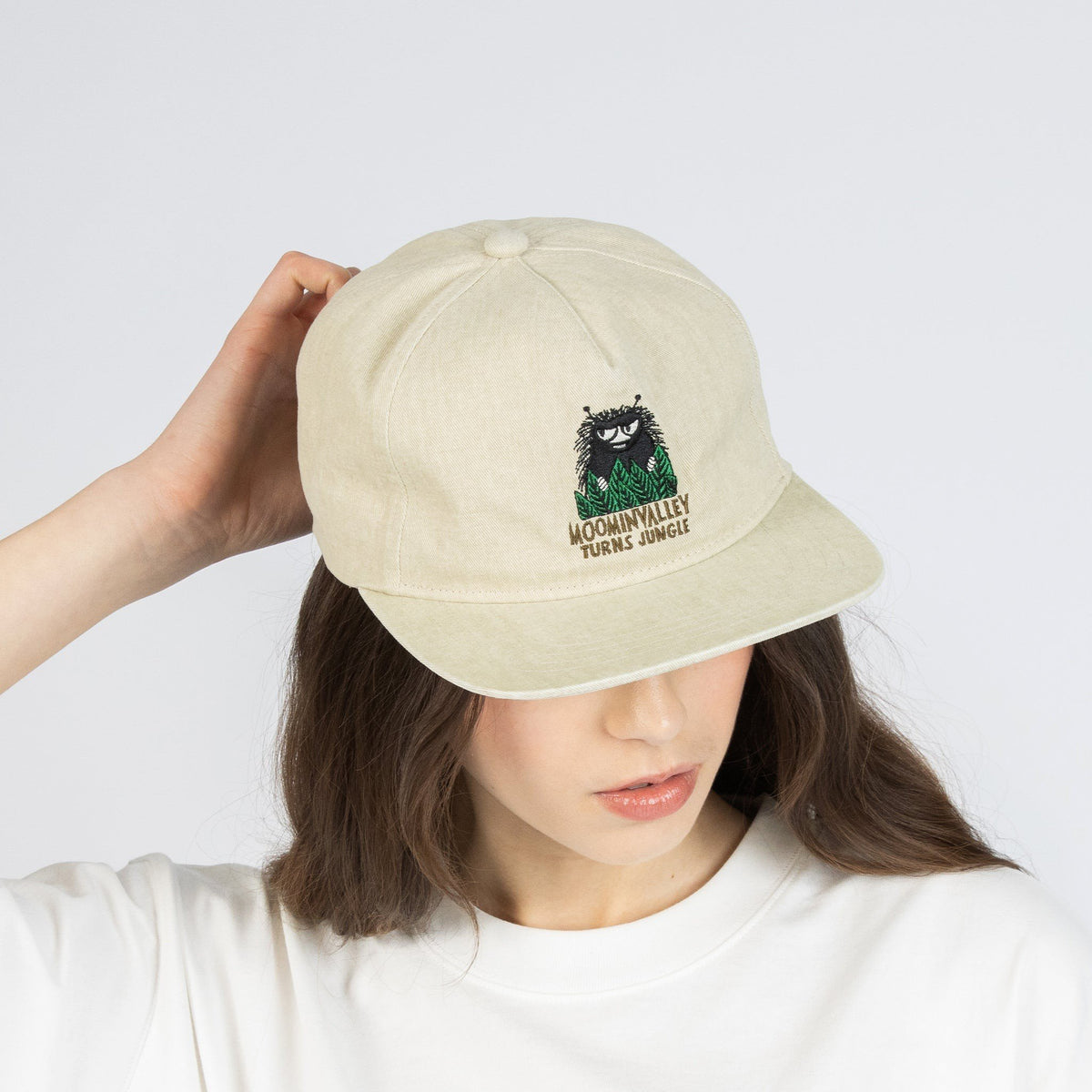 1. Woman wearing Moomin Washed Denim Adult Cap in Denim Beige, showcasing front design in studio setting