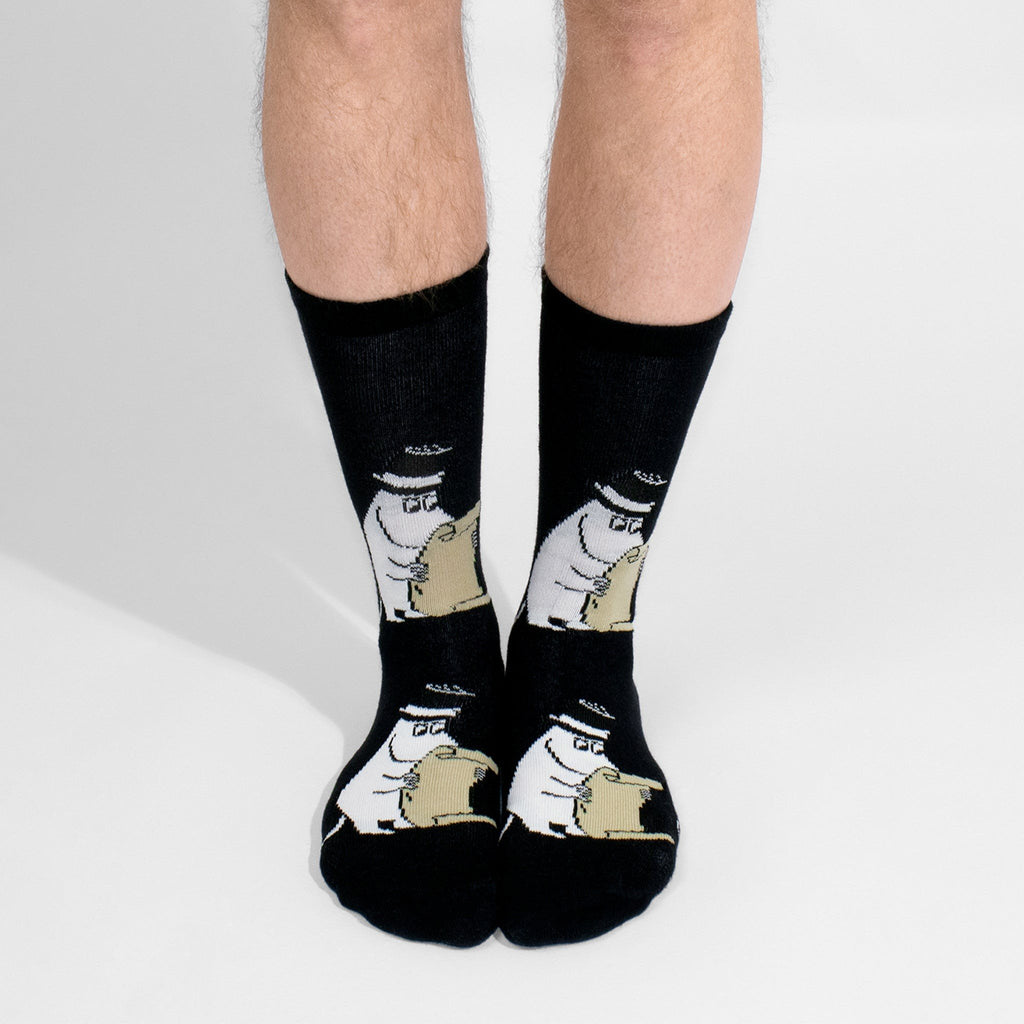 1. Men's Moominpappa socks by NordicBuddies worn by male model, showcasing playful Moomin design in lifestyle setting