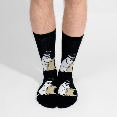 1. Men's Moominpappa socks by NordicBuddies worn by male model, showcasing playful Moomin design in lifestyle setting