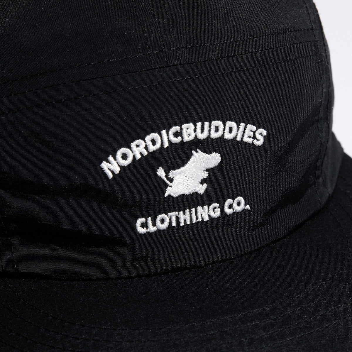 6. Close-up of NordicBuddies logo on black Moomintroll Adventure 5-panel cap
