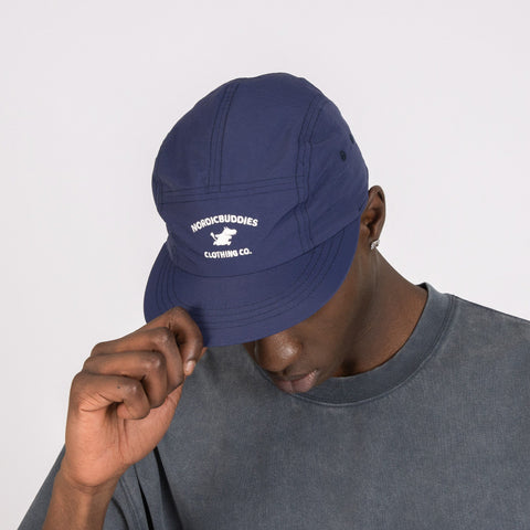 1. Men's navy Moomintroll Adventure 5-panel cap by NordicBuddies, worn by model in studio
