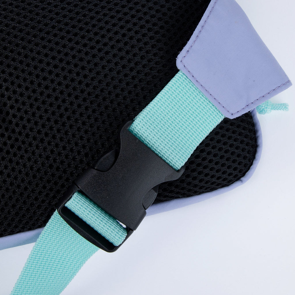 3. Close-up of mint strap and black buckle on lavender waist bag
